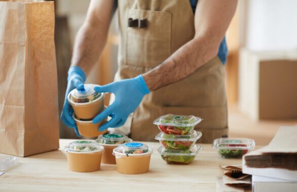 worker wearing gloves at food delivery service